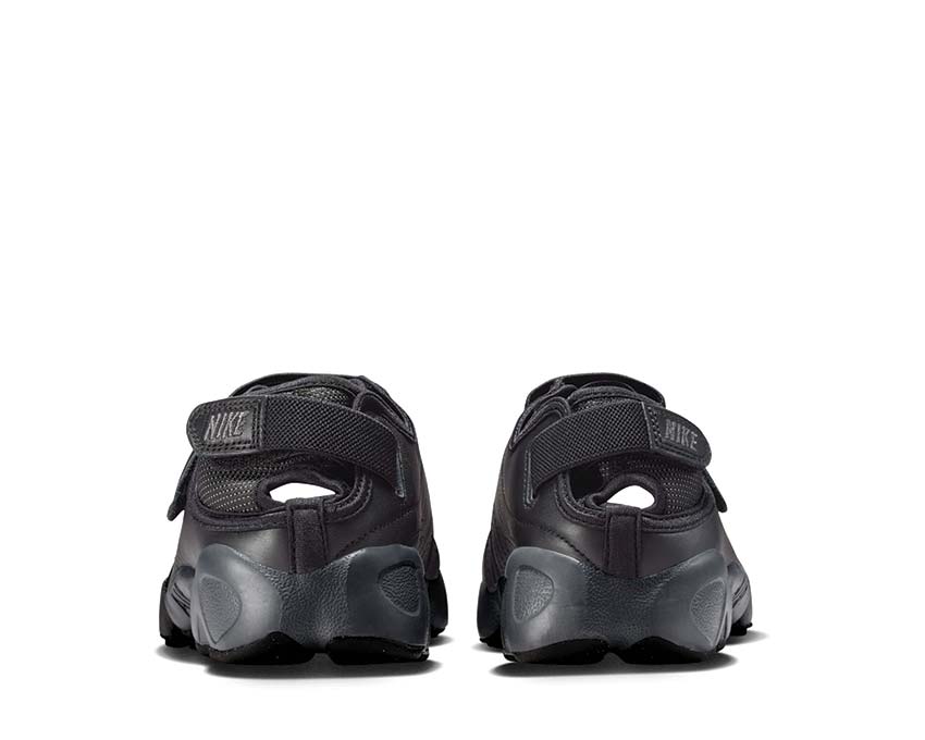 Scarpa sportiva da donna con design aperto e colore grigio scuro.