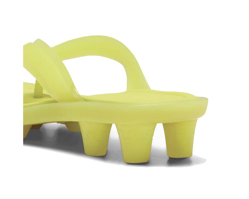 Scarpa sportiva con tacchetti in materiale trasparente e design contemporaneo.